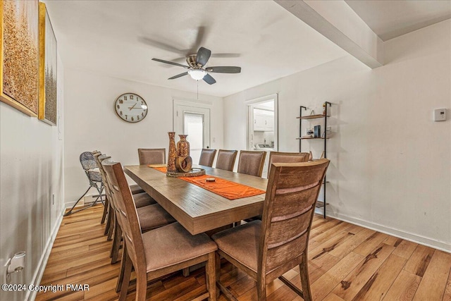 dining room with light wood-style floors, ceiling fan, and baseboards