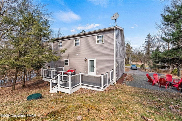 back of house featuring a wooden deck