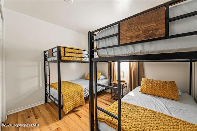 bedroom with baseboards and wood finished floors