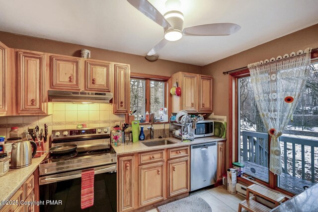 dining room featuring a baseboard radiator, light tile patterned floors, ceiling fan, and wood walls