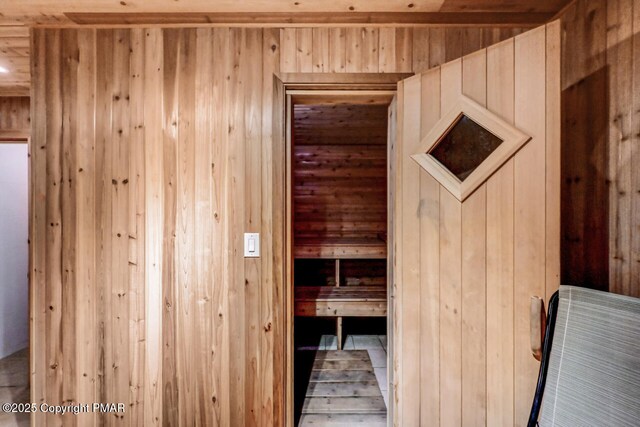 interior space with wood ceiling, light hardwood / wood-style flooring, and wood walls