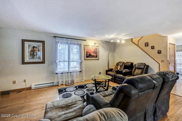 living room featuring a baseboard radiator and light hardwood / wood-style flooring