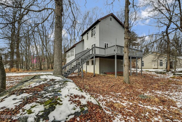 view of snow covered exterior featuring a wooden deck