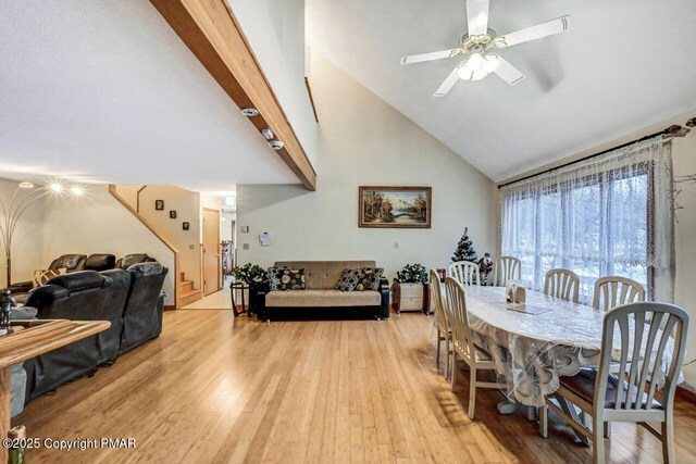 dining space featuring beamed ceiling, ceiling fan, high vaulted ceiling, and light hardwood / wood-style flooring