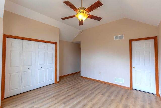 unfurnished bedroom with light wood finished floors, visible vents, and lofted ceiling