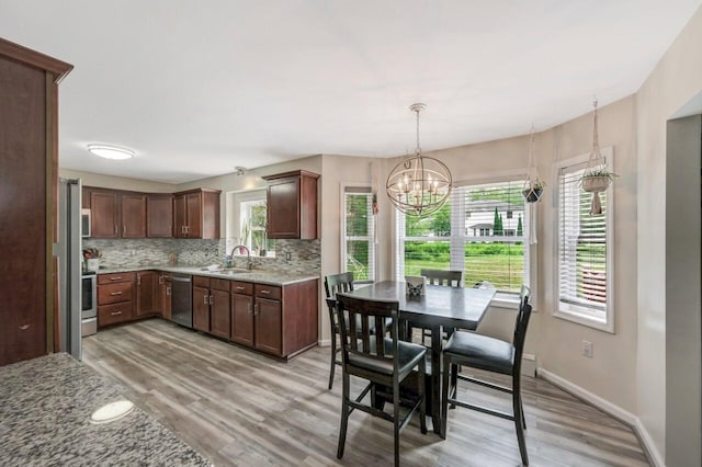 5117 Hounds Ear Rd, Tobyhanna, PA 18466 - kitchen with stainless steel appliances, decorative backsplash, light wood-type flooring, and healthy amount of natural light