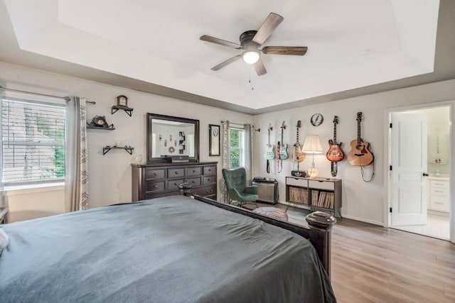 5117 Hounds Ear Rd, Tobyhanna, PA 18466 - bedroom with a raised ceiling, light wood-type flooring, ensuite bath, and ceiling fan