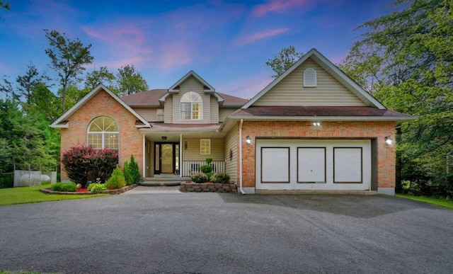 5117 Hounds Ear Rd, Tobyhanna, PA 18466 - view of front of home featuring driveway, brick siding, a porch, and an attached garage