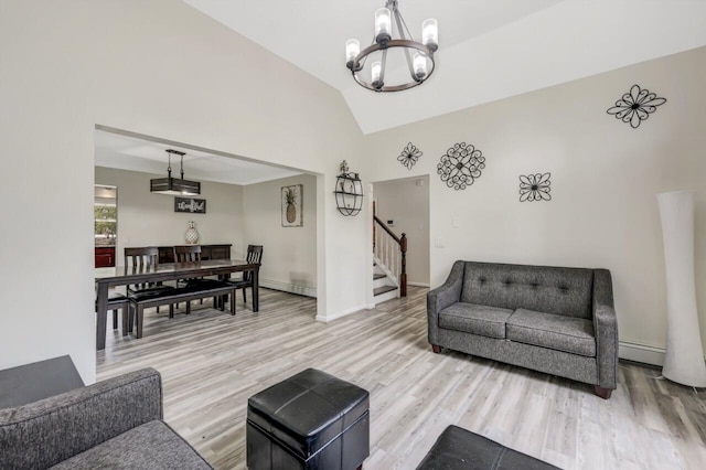 5117 Hounds Ear Rd, Tobyhanna, PA 18466 - living area with a chandelier, stairway, light wood-style flooring, baseboard heating, and vaulted ceiling