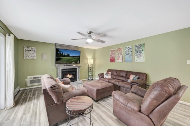 5117 Hounds Ear Rd, Tobyhanna, PA 18466 - living room with ceiling fan, wood finished floors, a warm lit fireplace, and a wall unit AC