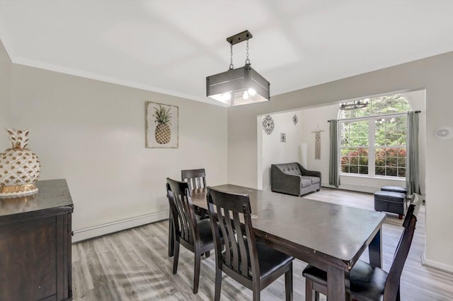 5117 Hounds Ear Rd, Tobyhanna, PA 18466 - dining area with baseboard heating, light wood finished floors, and ornamental molding