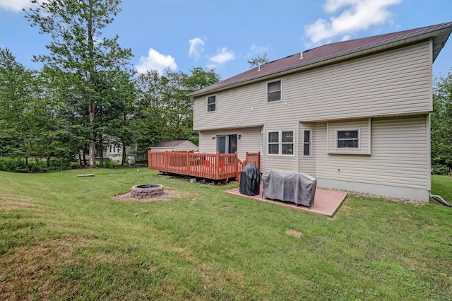 5117 Hounds Ear Rd, Tobyhanna, PA 18466 - rear view of property with an outdoor fire pit, a wooden deck, and a yard