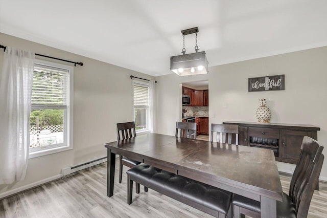 5117 Hounds Ear Rd, Tobyhanna, PA 18466 - dining area with a baseboard radiator and light wood finished floors