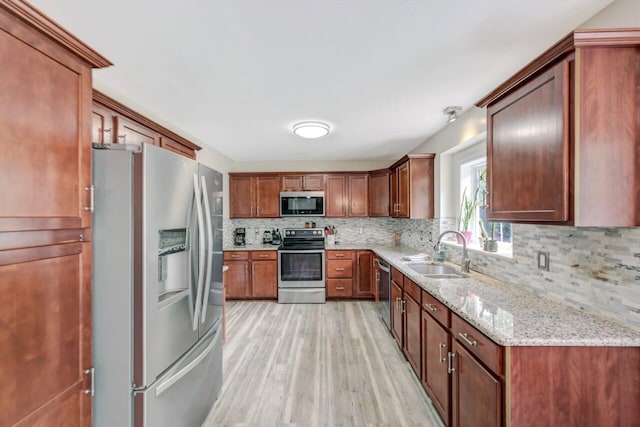 5117 Hounds Ear Rd, Tobyhanna, PA 18466 - kitchen featuring stainless steel appliances, light wood-style floors, decorative backsplash, and light stone countertops