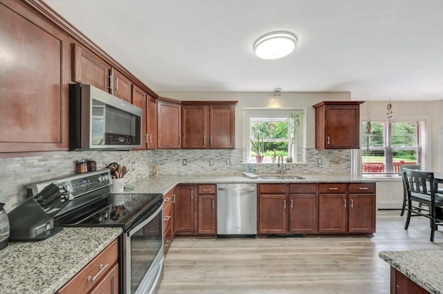 5117 Hounds Ear Rd, Tobyhanna, PA 18466 - kitchen featuring stainless steel appliances, light wood-style flooring, backsplash, and light stone countertops