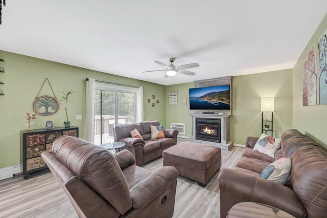 5117 Hounds Ear Rd, Tobyhanna, PA 18466 - living room with light wood-style floors, a ceiling fan, and a glass covered fireplace
