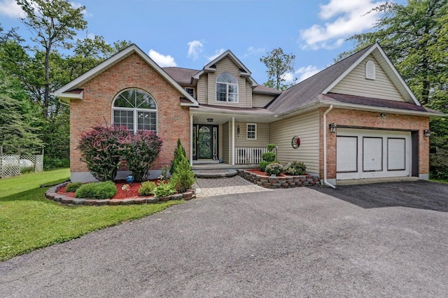 5117 Hounds Ear Rd, Tobyhanna, PA 18466 - view of front of home featuring driveway, covered porch, brick siding, an attached garage, and a front yard
