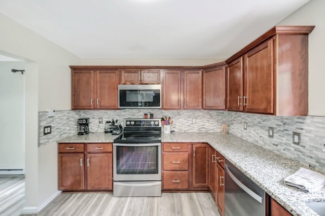 5117 Hounds Ear Rd, Tobyhanna, PA 18466 - kitchen with appliances with stainless steel finishes, light wood-style flooring, light stone counters, and tasteful backsplash