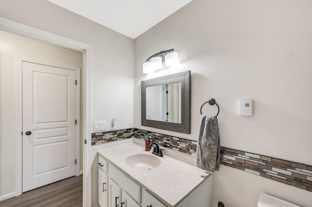5117 Hounds Ear Rd, Tobyhanna, PA 18466 - bathroom with decorative backsplash, vanity, and wood finished floors