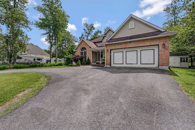 5117 Hounds Ear Rd, Tobyhanna, PA 18466 - single story home with driveway, brick siding, a garage, a front yard, and a storage unit