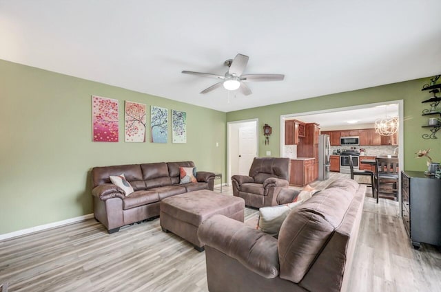 5117 Hounds Ear Rd, Tobyhanna, PA 18466 - living area with light wood-type flooring, ceiling fan, and a chandelier