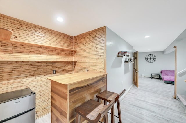 5117 Hounds Ear Rd, Tobyhanna, PA 18466 - indoor dry bar with light wood-type flooring, recessed lighting, wooden walls, fridge, and a baseboard radiator