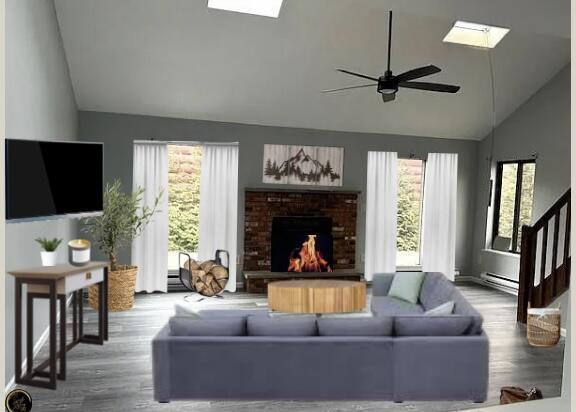 3073 Briarwood Dr, Tobyhanna, PA 18466 - living area featuring a skylight, high vaulted ceiling, plenty of natural light, and wood finished floors