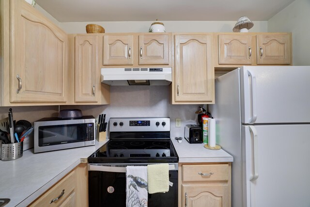 203 Wyomissing Dr, Pocono Lake, PA 18347 - kitchen featuring stainless steel appliances, light brown cabinetry, under cabinet range hood, and light countertops