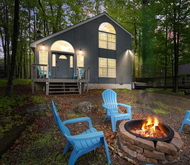 203 Wyomissing Dr, Pocono Lake, PA 18347 - back of house with an outdoor fire pit, a chimney, and covered porch