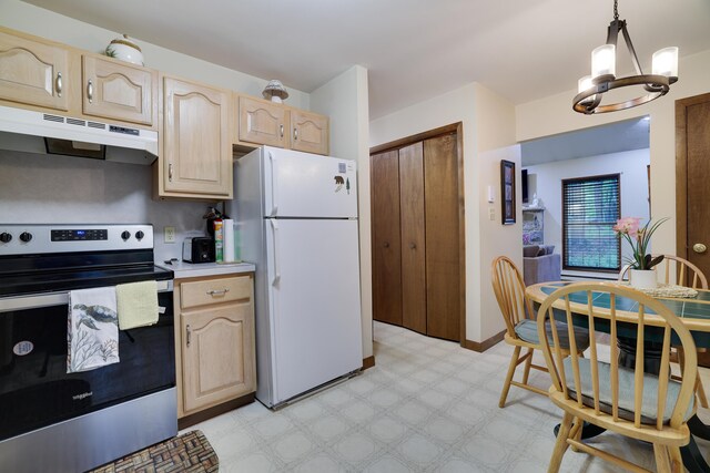 203 Wyomissing Dr, Pocono Lake, PA 18347 - kitchen with stainless steel range with electric cooktop, under cabinet range hood, freestanding refrigerator, light brown cabinetry, and a chandelier