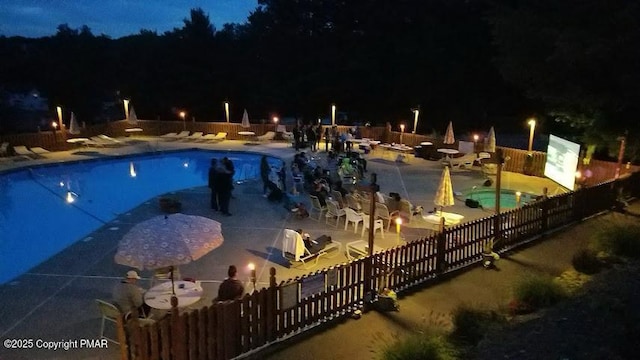 pool at night with a patio