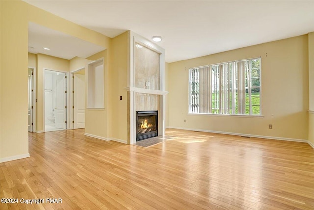 unfurnished living room with light wood-type flooring