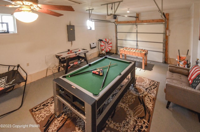 recreation room with a garage, pool table, and electric panel