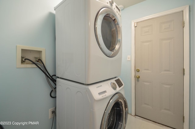 clothes washing area with laundry area and stacked washer / drying machine