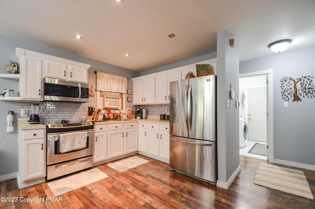 kitchen with open shelves, backsplash, appliances with stainless steel finishes, white cabinetry, and wood finished floors