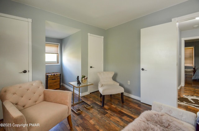 sitting room featuring baseboards and wood finished floors