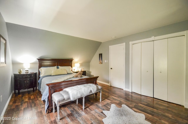 bedroom with a closet, wood finished floors, and baseboards