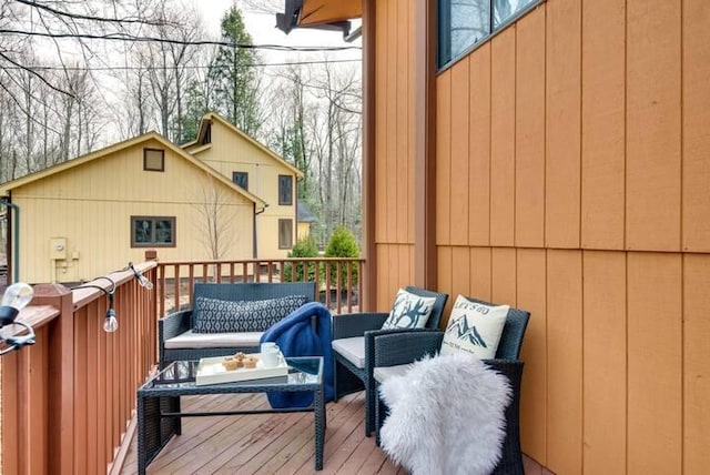 view of wooden balcony featuring a deck and an outdoor hangout area