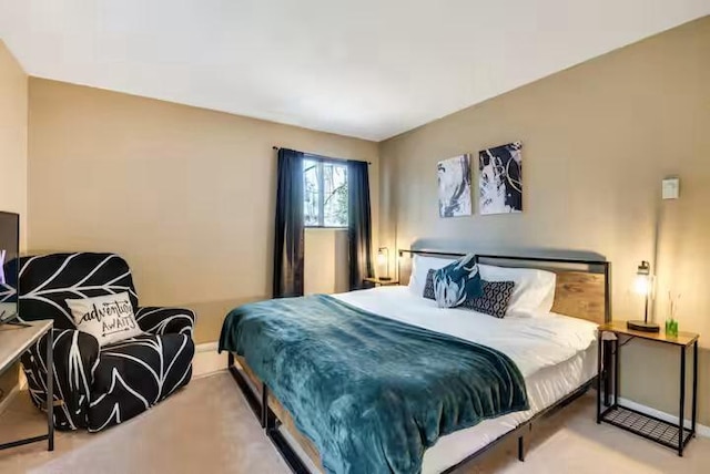 carpeted bedroom featuring baseboards