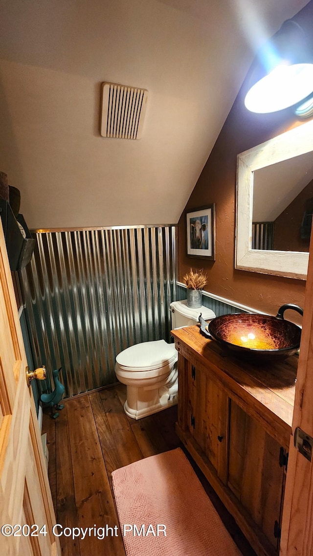 2124 Meadowlark Cir, Bushkill, PA 18324 - half bathroom with hardwood / wood-style flooring, lofted ceiling, and vanity