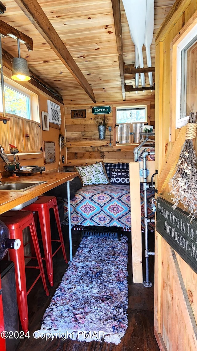 2124 Meadowlark Cir, Bushkill, PA 18324 - interior space featuring wood walls, a wooden ceiling with exposed beams, wood finished floors, and a wall mounted air conditioner