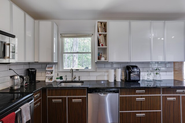 7042 Vista Dr, Tobyhanna, PA 18466 - kitchen with stainless steel appliances, white cabinetry, and dark brown cabinetry