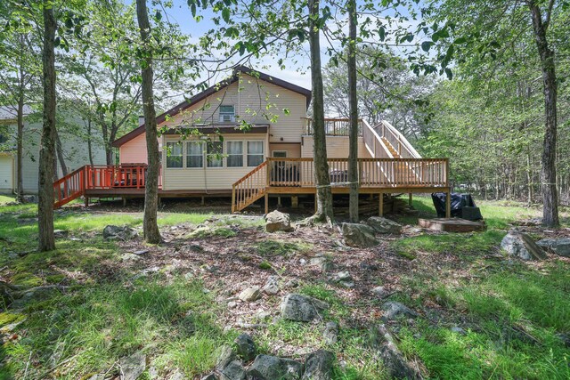 7042 Vista Dr, Tobyhanna, PA 18466 - back of property featuring stairway and a wooden deck