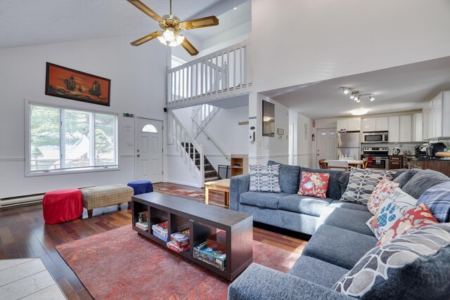 7042 Vista Dr, Tobyhanna, PA 18466 - living room with stairway, wood finished floors, a ceiling fan, and high vaulted ceiling