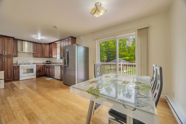 233 Vista Rd, Cresco, PA 18326 - kitchen with appliances with stainless steel finishes, wall chimney range hood, a baseboard radiator, light countertops, and light wood finished floors