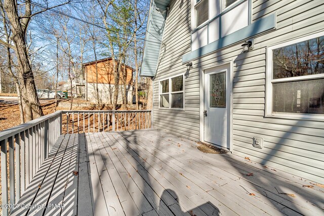 view of front of property with a storage unit and a deck