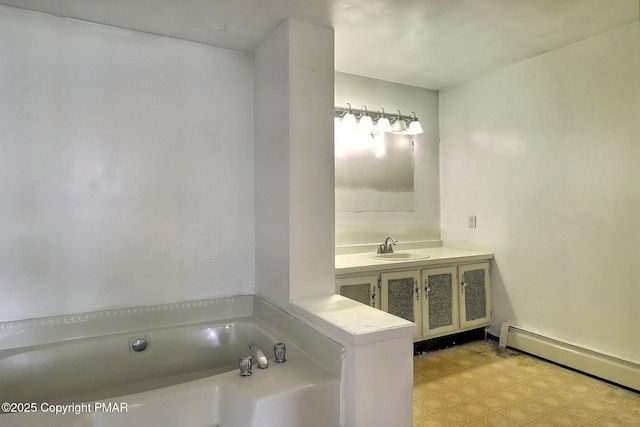 bathroom featuring sink, a washtub, and baseboard heating