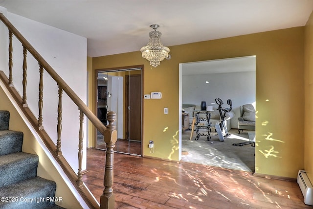 foyer with an inviting chandelier and a baseboard radiator