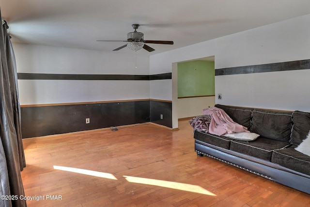 living room with light hardwood / wood-style flooring and ceiling fan