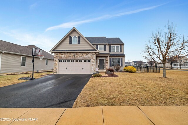 view of front of home with a garage and a front yard